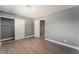 Spacious bedroom with grey walls, wood-look floors, and a door to hallway at 3802 Terrazzo Ave, Las Vegas, NV 89115