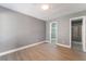 Bright bedroom with grey walls, wood-look floors, and a spacious closet at 3802 Terrazzo Ave, Las Vegas, NV 89115