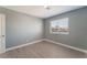 This room features gray walls, modern flooring, and a large window providing natural light and curb appeal at 3802 Terrazzo Ave, Las Vegas, NV 89115