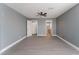 Spacious bedroom featuring wood-look floors, a ceiling fan and a view into the laundry room at 3802 Terrazzo Ave, Las Vegas, NV 89115