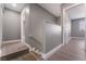 Hallway with wood-look flooring leading to a bedroom, and a staircase with a white handrail at 3802 Terrazzo Ave, Las Vegas, NV 89115