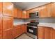 Kitchen featuring stainless steel appliances, wood cabinets, and light countertops at 3802 Terrazzo Ave, Las Vegas, NV 89115