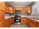 Renovated kitchen with oak cabinets and stainless steel appliances at 3802 Terrazzo Ave, Las Vegas, NV 89115