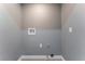 A well-lit laundry area shows utility connections, and a textured gray paint for a clean, functional space at 3802 Terrazzo Ave, Las Vegas, NV 89115