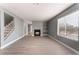 Living room with fireplace, wood-look floors, and staircase at 3802 Terrazzo Ave, Las Vegas, NV 89115