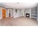 Spacious living room with wood-look floors, fireplace, staircase, and bright window at 3802 Terrazzo Ave, Las Vegas, NV 89115