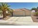 Attached three-car garage with driveway and desert landscaping at 4624 Standing Bluff Way, Las Vegas, NV 89130