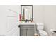 Elegant powder room with gray vanity and white toilet at 49 Vista Outlook St, Henderson, NV 89011