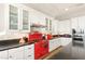 Modern kitchen with red stove and white cabinets at 49 Vista Outlook St, Henderson, NV 89011