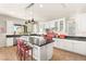 Bright kitchen with white cabinets, granite counters, and island at 49 Vista Outlook St, Henderson, NV 89011