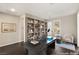 Virtually staged home office with a large desk and built-in shelving at 49 Vista Outlook St, Henderson, NV 89011