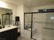 Modern bathroom with walk-in shower and floating vanity at 5773 Holbeche St, Las Vegas, NV 89113