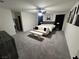 Spacious main bedroom with plush carpet, large bed and seating at 5773 Holbeche St, Las Vegas, NV 89113