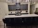 Modern kitchen with dark cabinetry, quartz countertops and island with seating at 5773 Holbeche St, Las Vegas, NV 89113