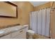 Clean bathroom, granite countertop, white cabinets and shower/tub combo at 5908 Aqua Verde St, North Las Vegas, NV 89031