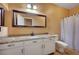 Bathroom with granite countertop, white cabinets and shower/tub combo at 5908 Aqua Verde St, North Las Vegas, NV 89031