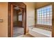 Relaxing bathroom with soaking tub and adjacent bedroom access at 5908 Aqua Verde St, North Las Vegas, NV 89031