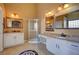 Elegant bathroom with double vanity, granite countertop and corner shower at 5908 Aqua Verde St, North Las Vegas, NV 89031