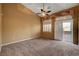 Spacious bedroom with carpet flooring, ceiling fan, and sliding glass door at 5908 Aqua Verde St, North Las Vegas, NV 89031