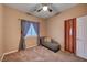 Bright bedroom featuring a daybed, window with blinds, and ceiling fan at 5908 Aqua Verde St, North Las Vegas, NV 89031