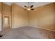 Well-lit bedroom with carpet flooring and access to hallway at 5908 Aqua Verde St, North Las Vegas, NV 89031