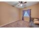 Bedroom with neutral decor, ceiling fan, and window with shutters at 5908 Aqua Verde St, North Las Vegas, NV 89031