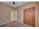 Bedroom with wood closet doors and access to another room at 5908 Aqua Verde St, North Las Vegas, NV 89031