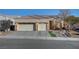 Single-story house with three-car garage and landscaped front yard at 5908 Aqua Verde St, North Las Vegas, NV 89031