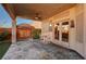 Covered patio with stone tile flooring, table and chairs at 5908 Aqua Verde St, North Las Vegas, NV 89031