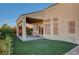 Relaxing patio area with covered seating and artificial turf at 5908 Aqua Verde St, North Las Vegas, NV 89031