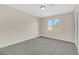 Simple bedroom with grey carpet and window, offering natural light at 5912 Royal Castle Ln, Las Vegas, NV 89130