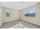 Spacious bedroom with neutral walls and carpet, featuring large windows and an ensuite bathroom at 5912 Royal Castle Ln, Las Vegas, NV 89130