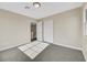 Well-lit bedroom with grey carpet, neutral walls, and access to hallway and upper floor at 5912 Royal Castle Ln, Las Vegas, NV 89130