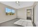 Bright bedroom with grey carpet, featuring large windows and access to hallway at 5912 Royal Castle Ln, Las Vegas, NV 89130