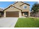 Two-story house with brown garage door and artificial turf at 5912 Royal Castle Ln, Las Vegas, NV 89130