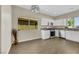 Modern kitchen with white cabinets, stainless steel appliances, and vinyl flooring at 5912 Royal Castle Ln, Las Vegas, NV 89130