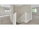 Upstairs hall with white railings and light-colored walls at 5912 Royal Castle Ln, Las Vegas, NV 89130