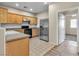 Efficient kitchen with stainless steel appliances, tile flooring and ample cabinet space at 5915 Nuevo Leon St # 7, North Las Vegas, NV 89031