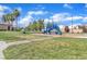 Community playground with green grass and blue play structure provides a recreational space at 5915 Nuevo Leon St # 7, North Las Vegas, NV 89031