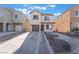 Two story house with brown garage door and landscaped yard at 6287 Felicitas Ave, Las Vegas, NV 89122