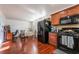 Kitchen with wood cabinets, black appliances, and small dining area at 6287 Felicitas Ave, Las Vegas, NV 89122