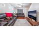 Living room with hardwood floors, leather couches and a large TV at 6287 Felicitas Ave, Las Vegas, NV 89122