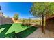 Landscaped backyard with artificial turf and trees at 712 Rogue Wave St, Las Vegas, NV 89138