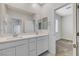 Double vanity bathroom with neutral tones and good lighting at 712 Rogue Wave St, Las Vegas, NV 89138