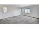 Spacious bedroom with window and neutral carpet at 712 Rogue Wave St, Las Vegas, NV 89138