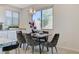 Elegant dining area with modern light fixture and seating for six at 712 Rogue Wave St, Las Vegas, NV 89138