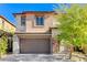 Two story home with brown garage door and stone accents at 712 Rogue Wave St, Las Vegas, NV 89138