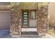 Front entry with stone pillars and a modern door at 712 Rogue Wave St, Las Vegas, NV 89138