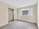 Bright bedroom with mirrored closet doors and window with shutters at 7933 Decker Canyon Dr # 101, Las Vegas, NV 89128