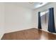 Bedroom with hardwood floors, window, and blue curtains at 7933 Grey Teal St, North Las Vegas, NV 89084